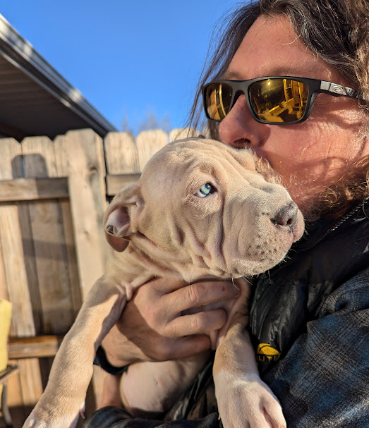 John holding a foster puppy